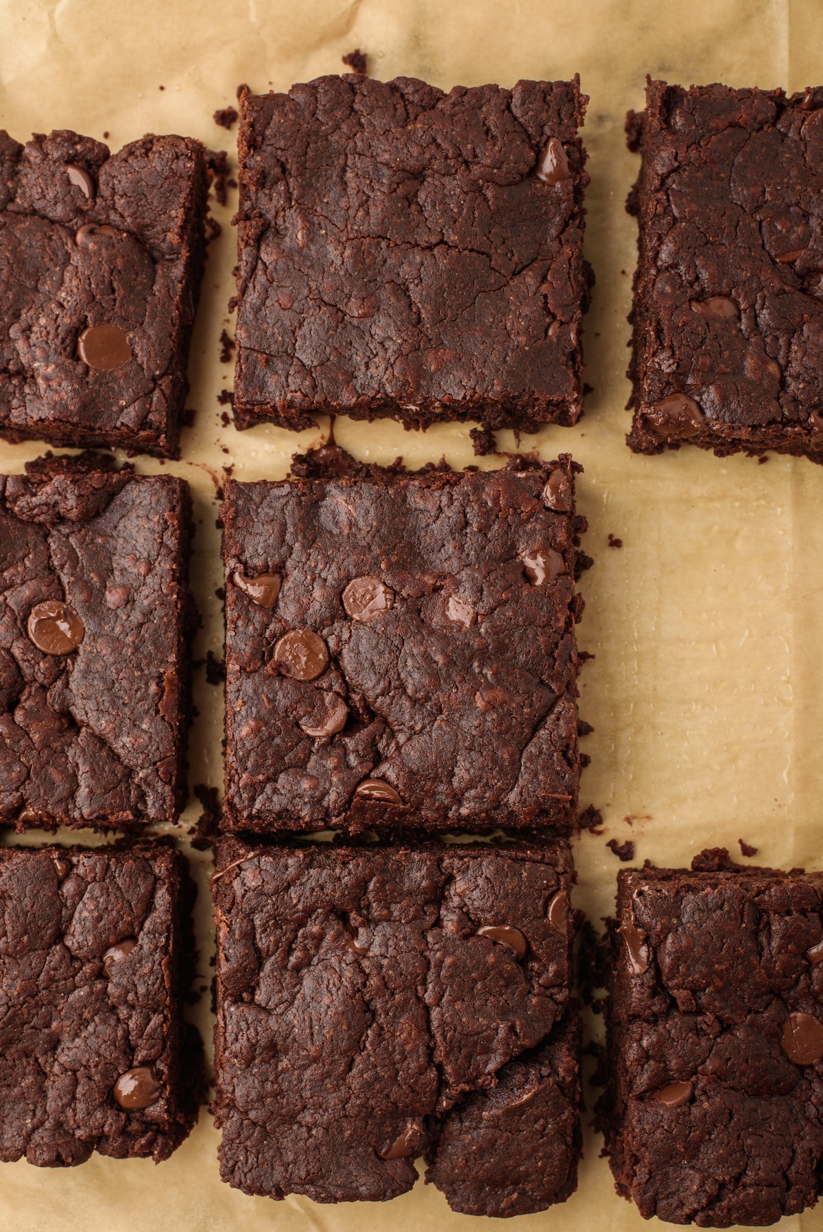 brownies laid out of brown paper with chocolate chips baked in.