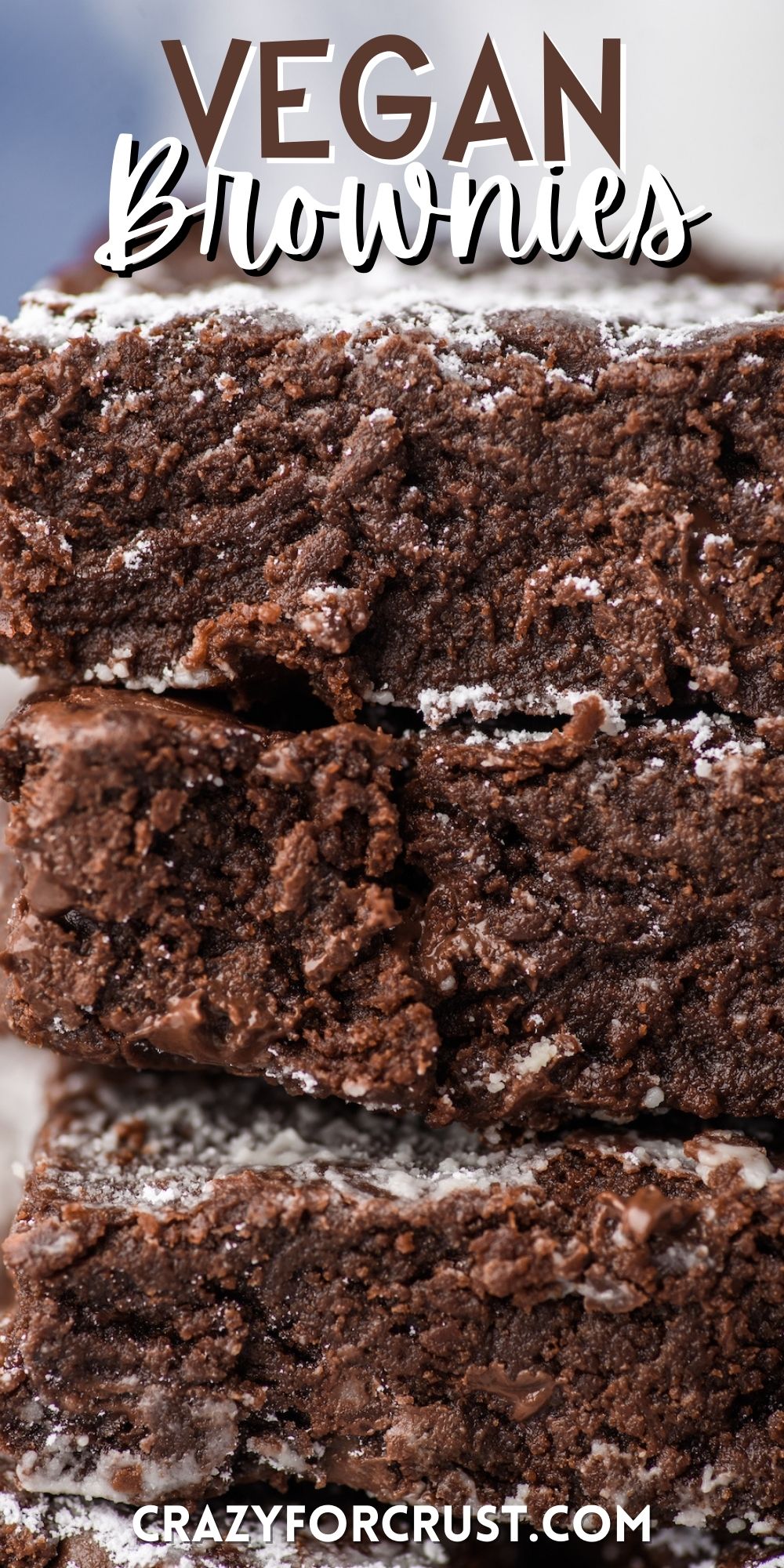 stacked brownies with powdered sugar sprinkled on top with words on the image.