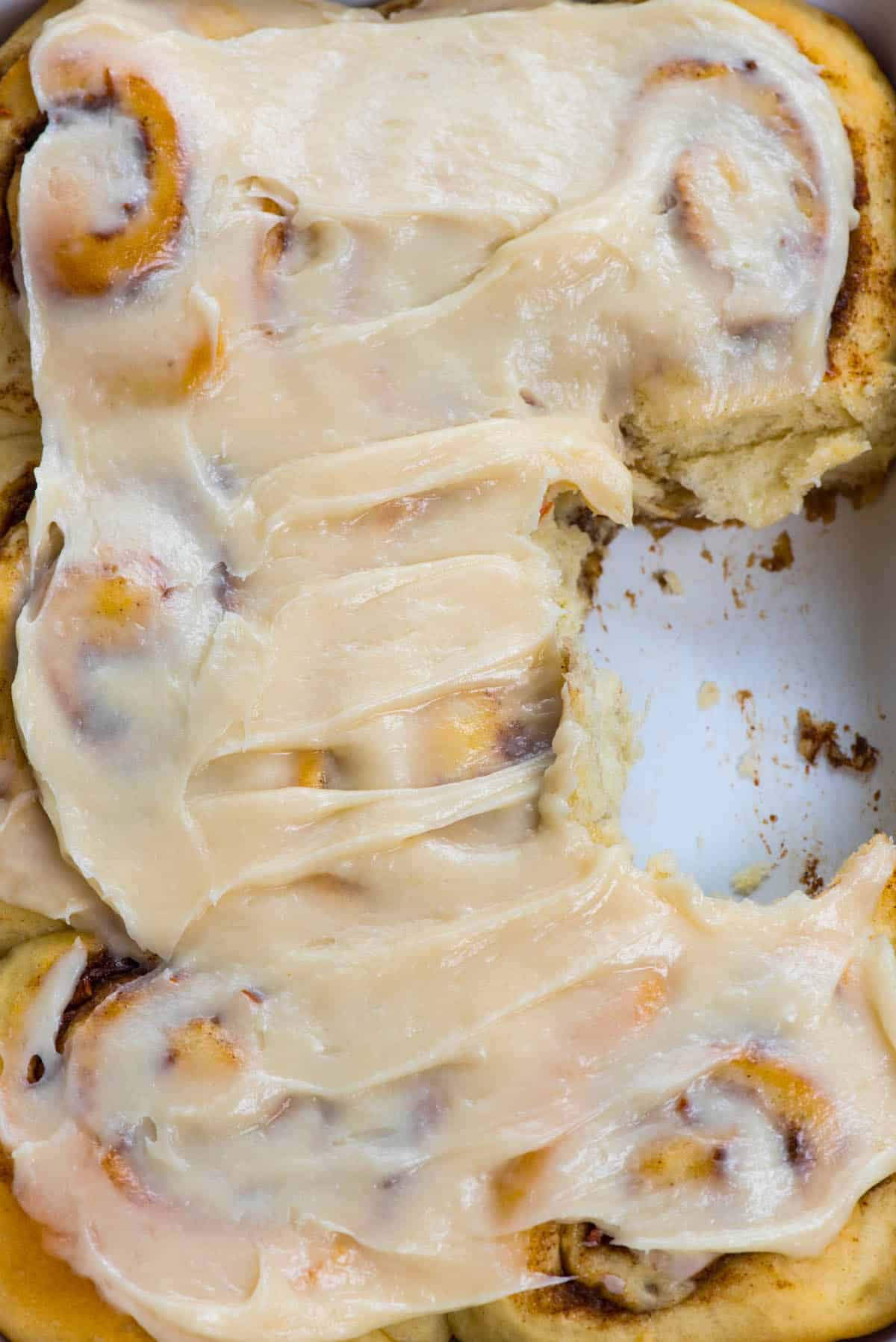 cinnamon rolls with carrots baked in on a white plate.