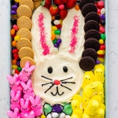 bunny shaped out of frosting and surrounded by jelly beans, marshmallows and oreos.