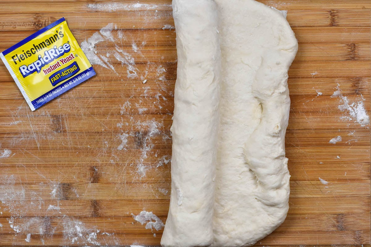rolled bread dough on cutting board