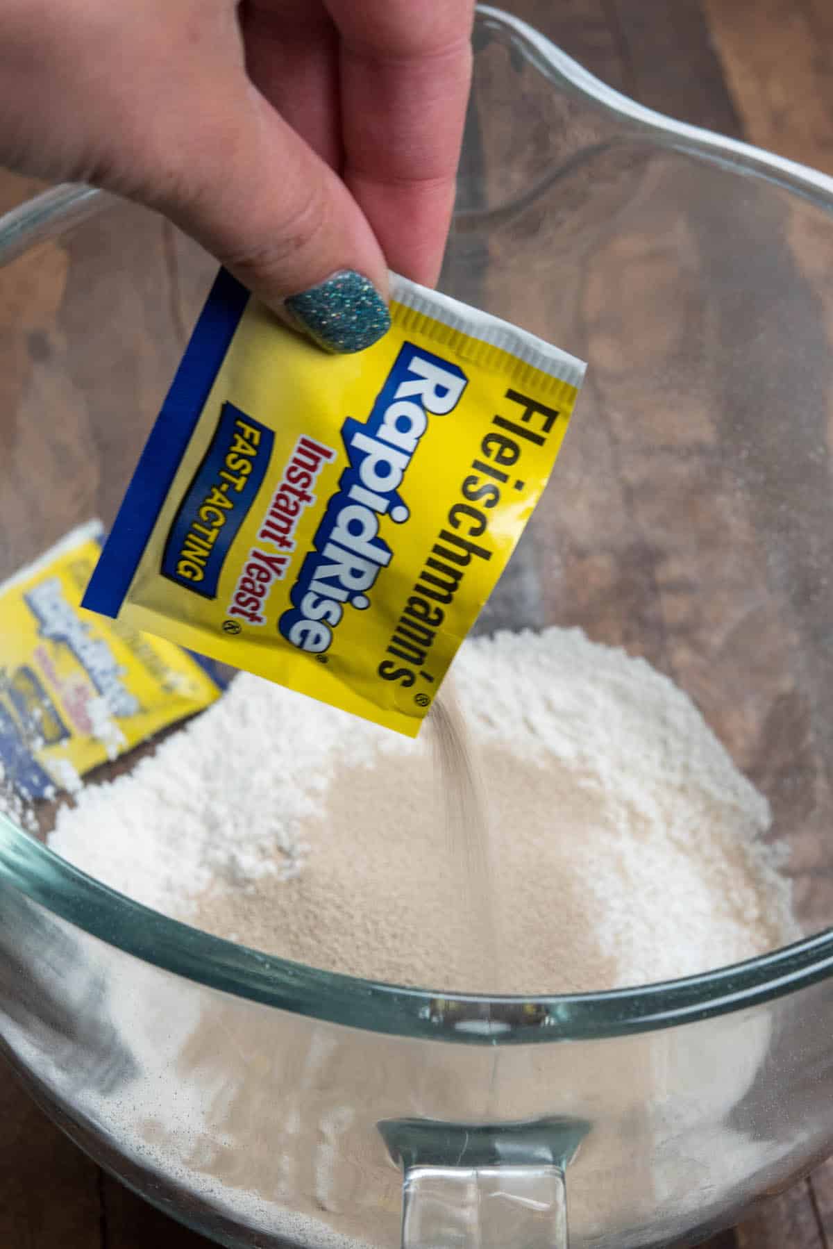 pouring yeast into glass bowl.