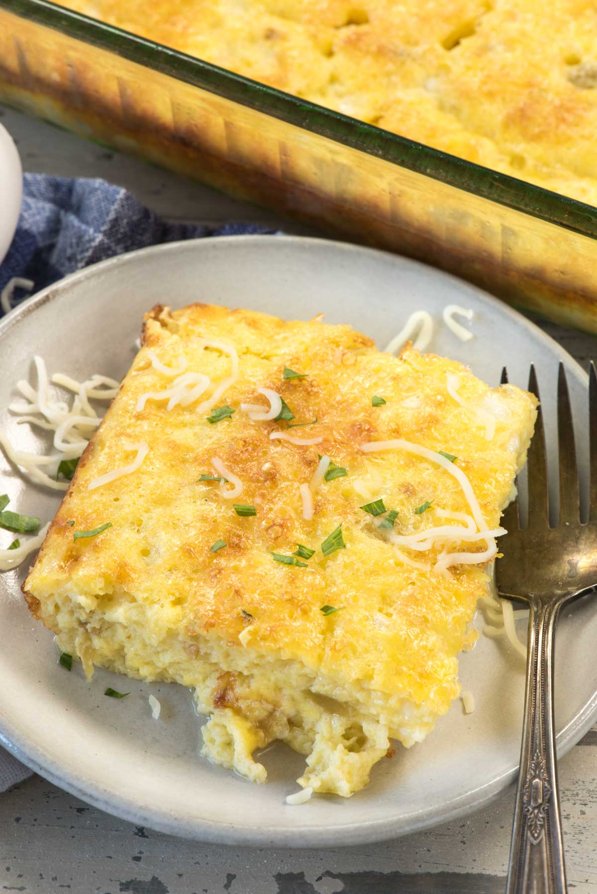 square slice of egg casserole with green chilis baked in.