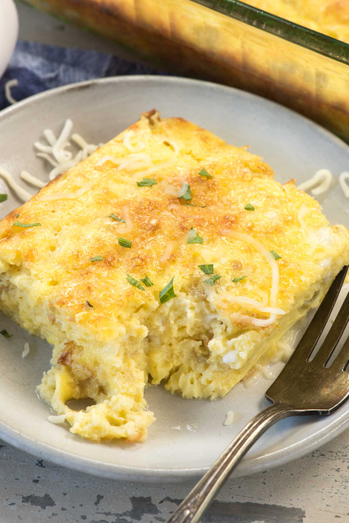 square slice of egg casserole with green chilis baked in.