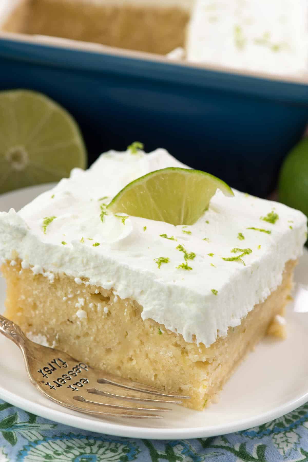 one slice of key lime cake with a sliced lime on top.