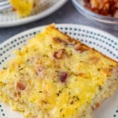 one slice of egg casserole with bacon baked in with word on the photo.