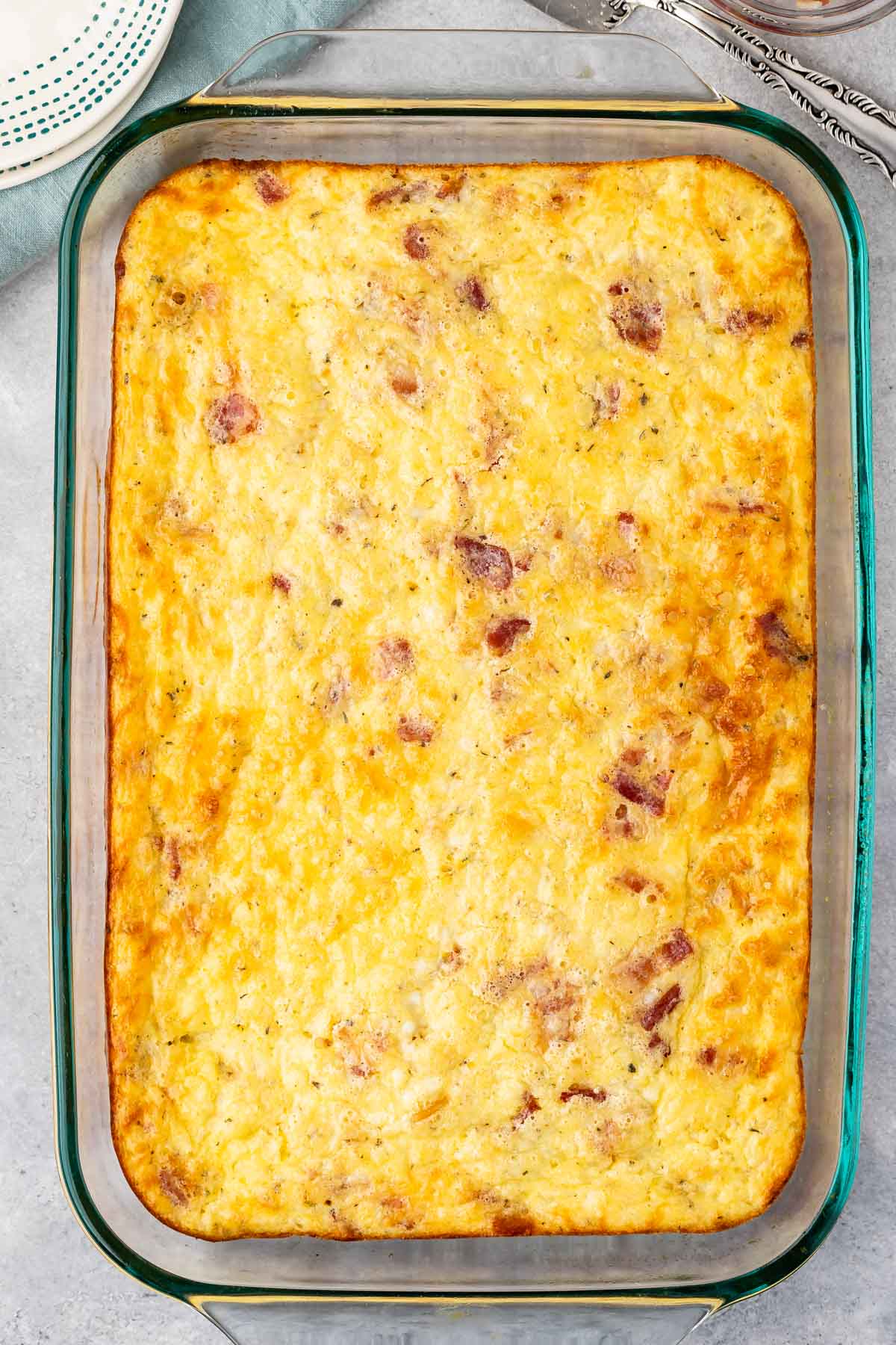 egg casserole in clear pan with bacon baked in.