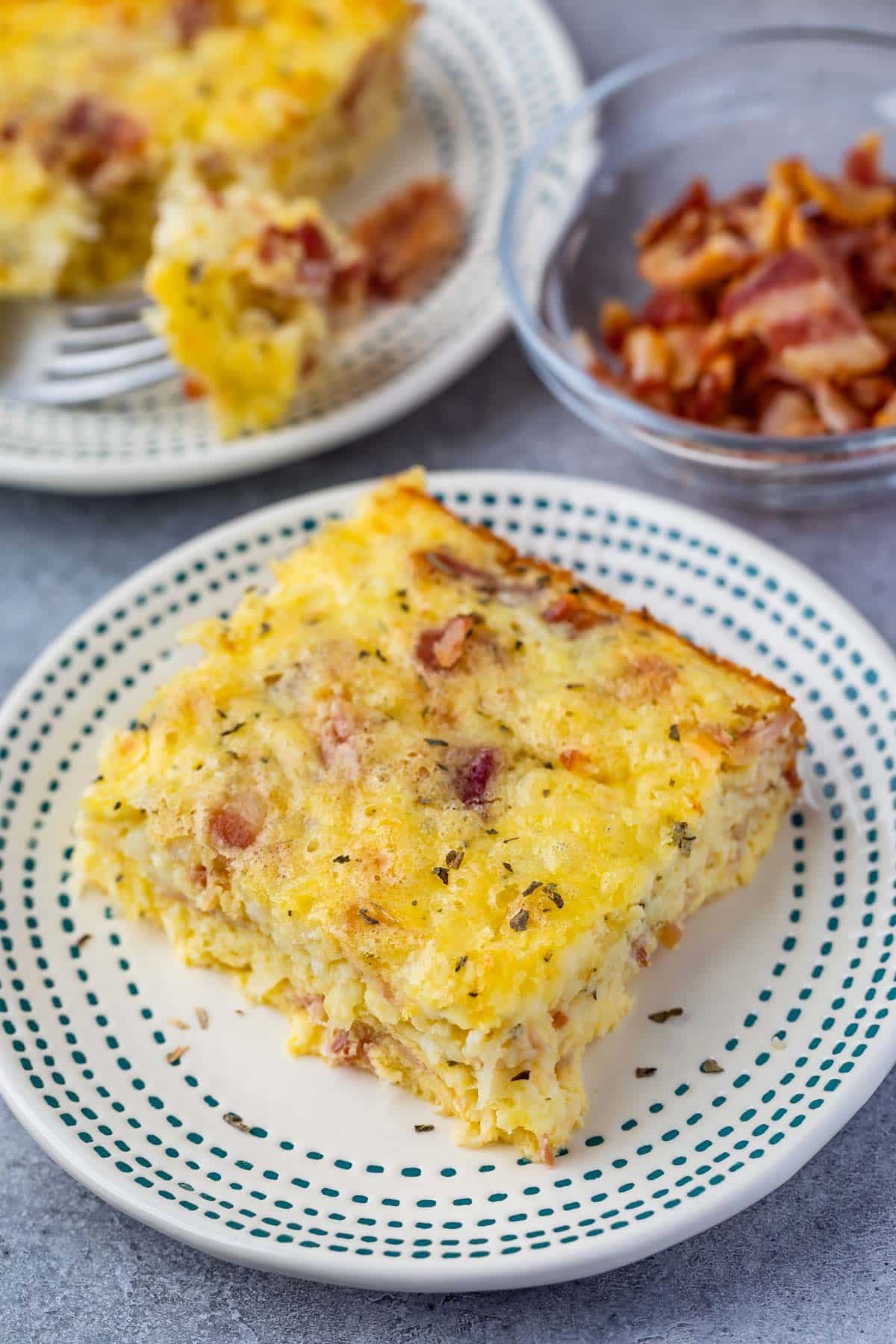 one slice of egg casserole with bacon baked in.