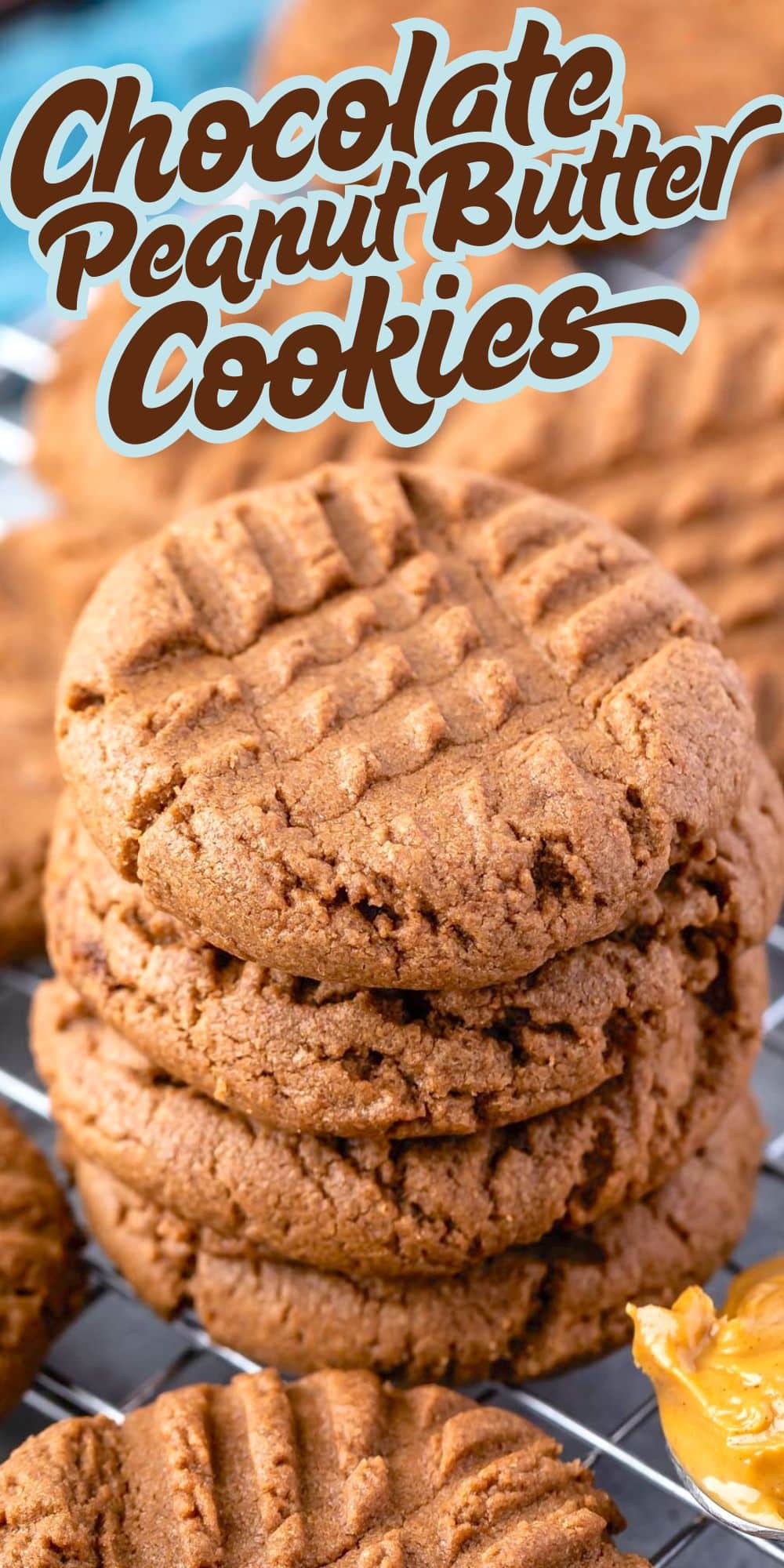 A close-up of chocolate peanut butter cookies stacked on a cooling rack, with “Chocolate Peanut Butter Cookies” in stylized text above and a small spoonful of peanut butter beside the freshly baked treats.