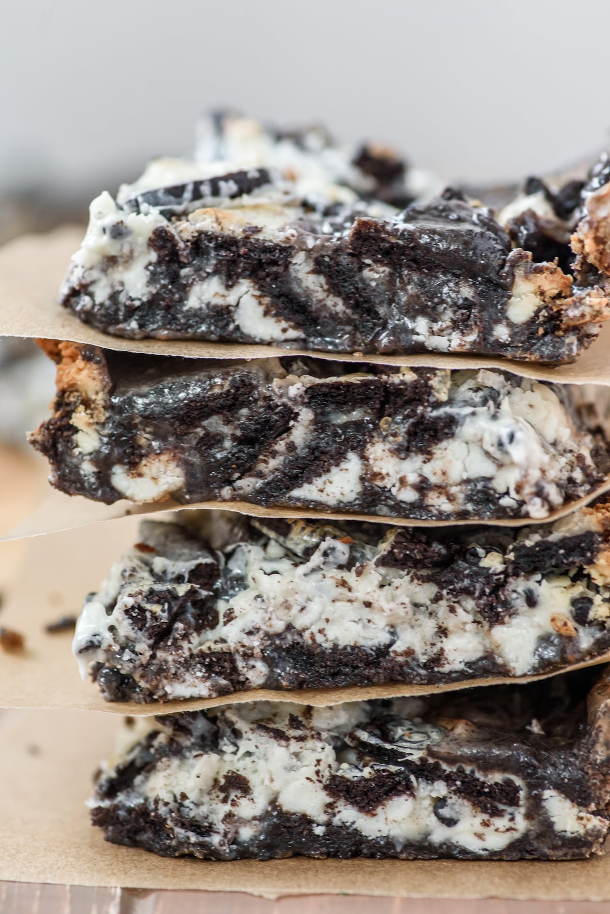 stacked oreo bars with parchment paper in between bars.