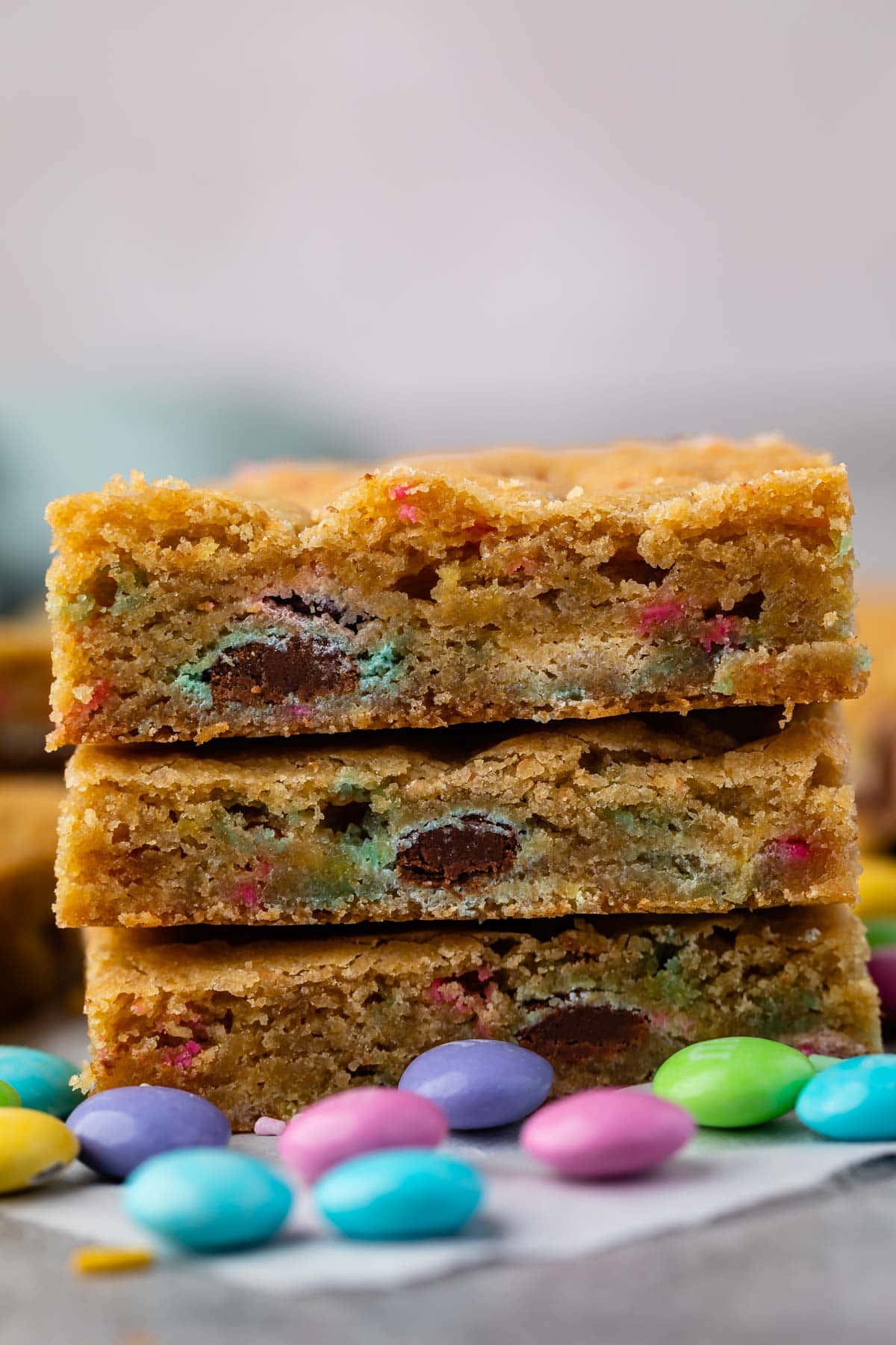 stack of 3 cookie bars with m&ms around.