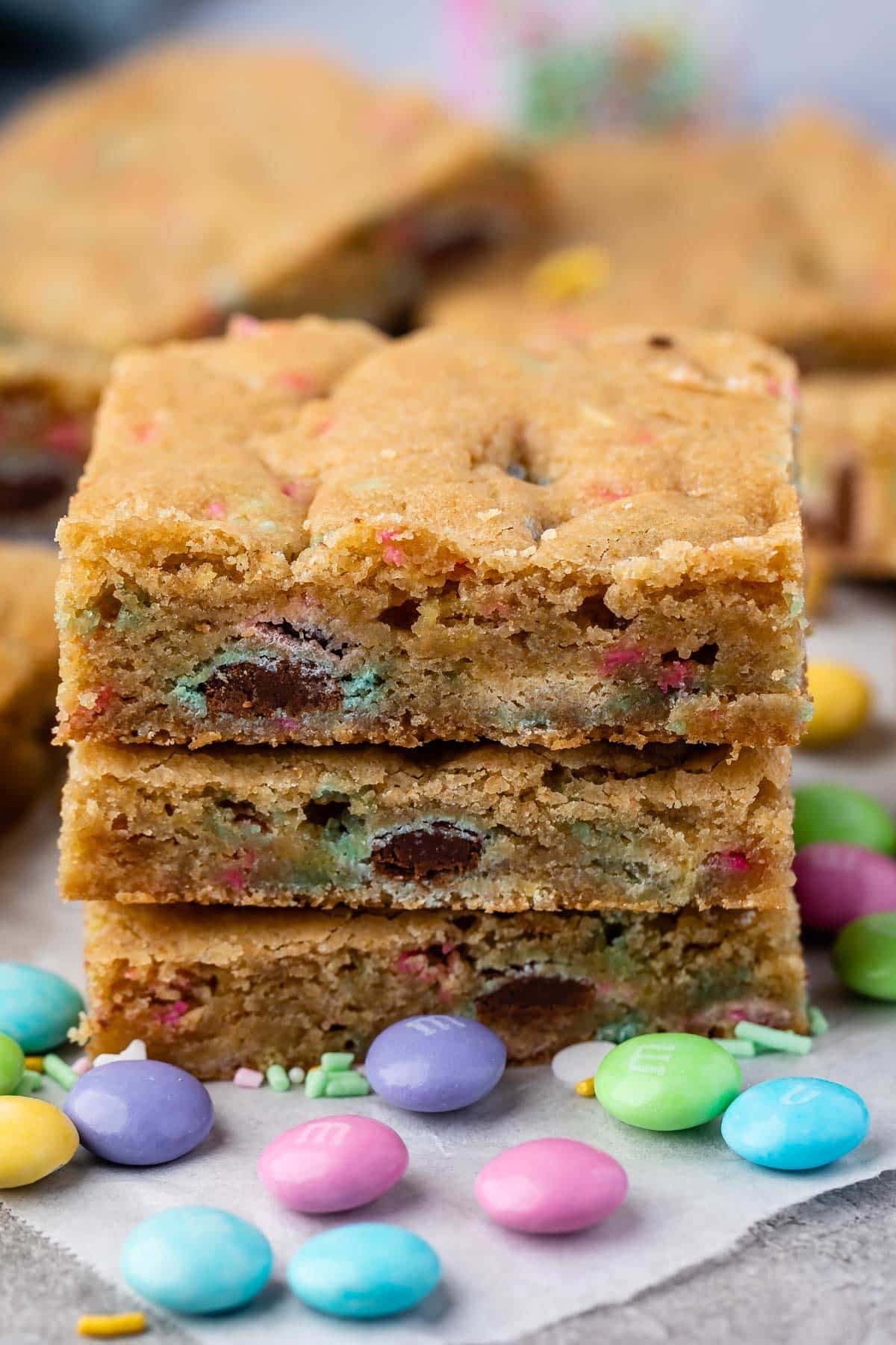 stack of 3 cookie bars with m&ms around.
