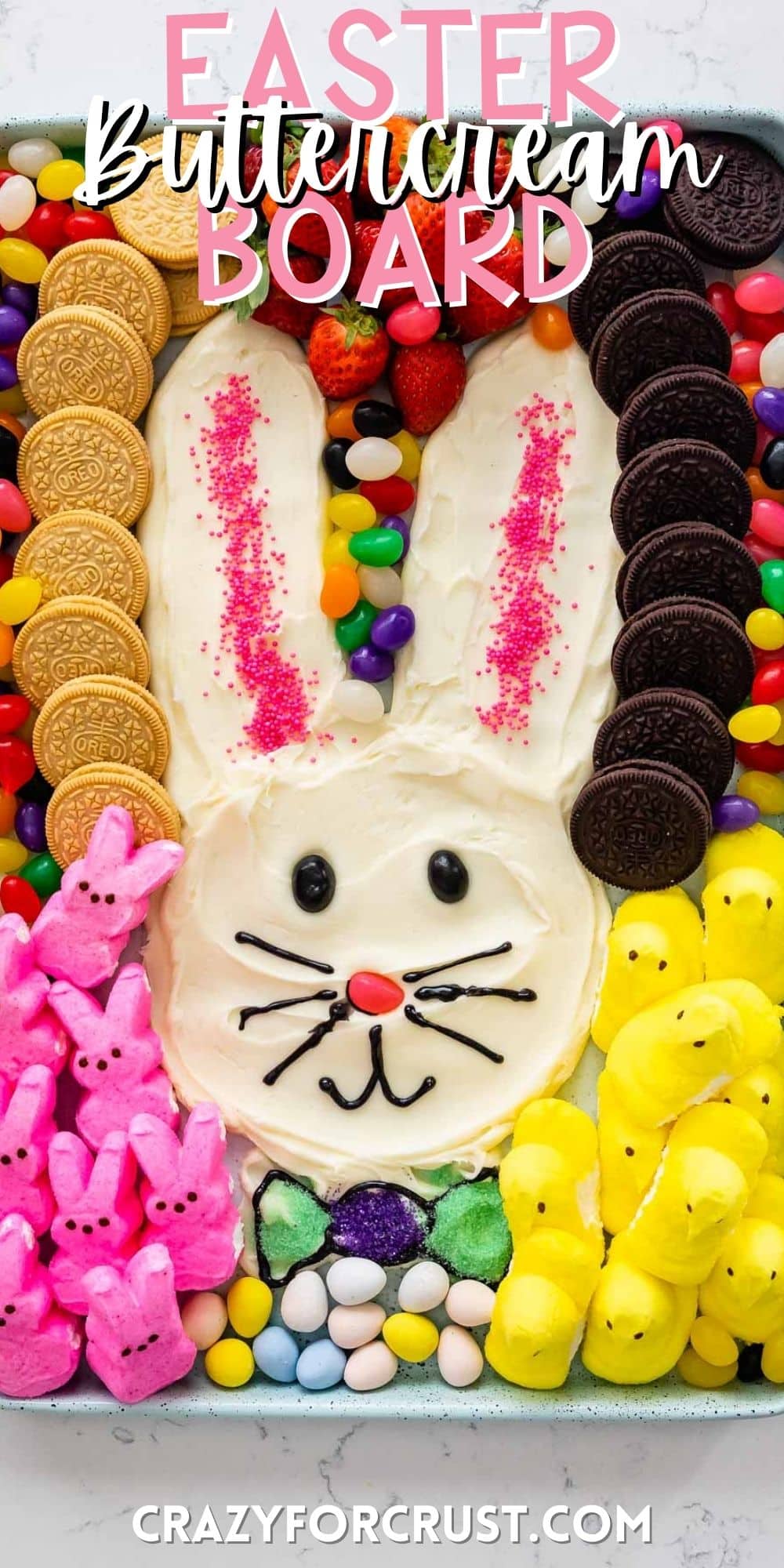 bunny shaped out of frosting and surrounded by jelly beans, marshmallows and oreos with words on the image.