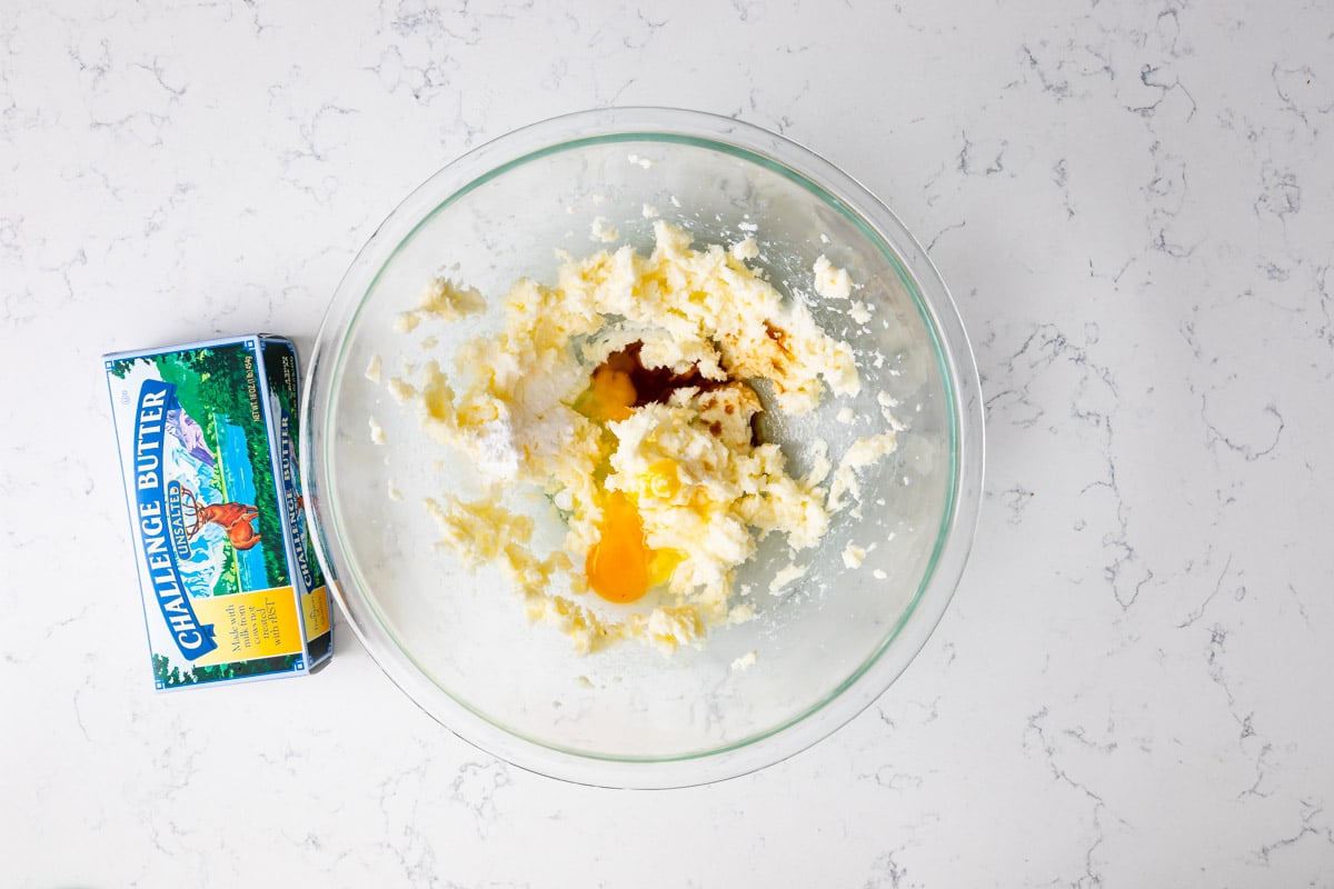 dough with egg and vanilla in bowl with butter box.