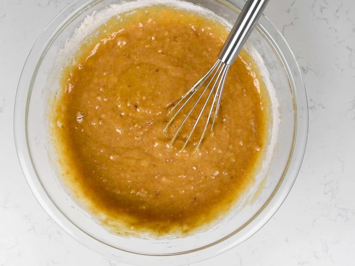 cake batter in glass bowl with whisk.