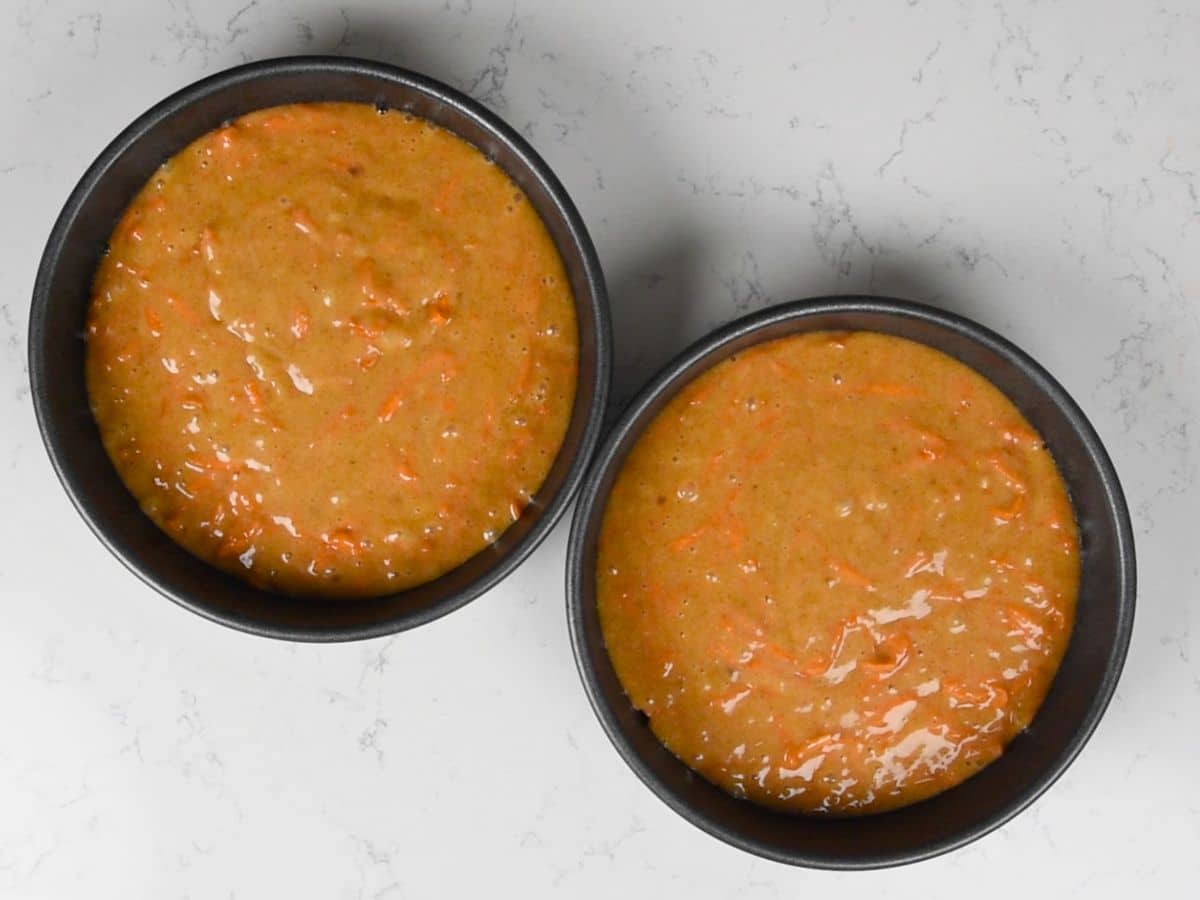 cake batter in two round pans.