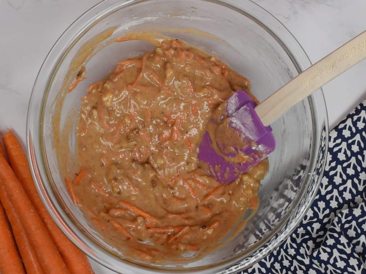 carrot cake mixture in clear bowl.