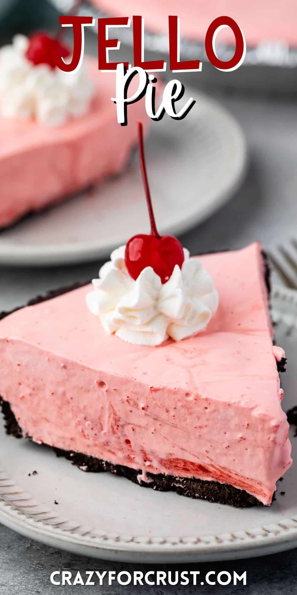 slice of pink pie on oreo crust with whipped cream and a cherry on top with words on the image.