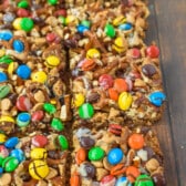 magic bars with nuts, pretzels and m&ms on top.