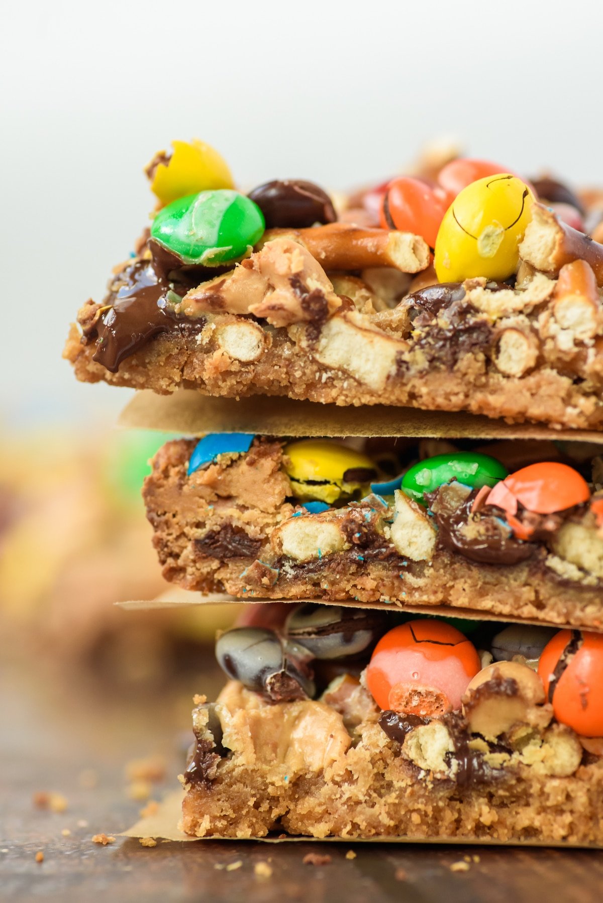 magic bars with nuts, pretzels and m&ms on top.