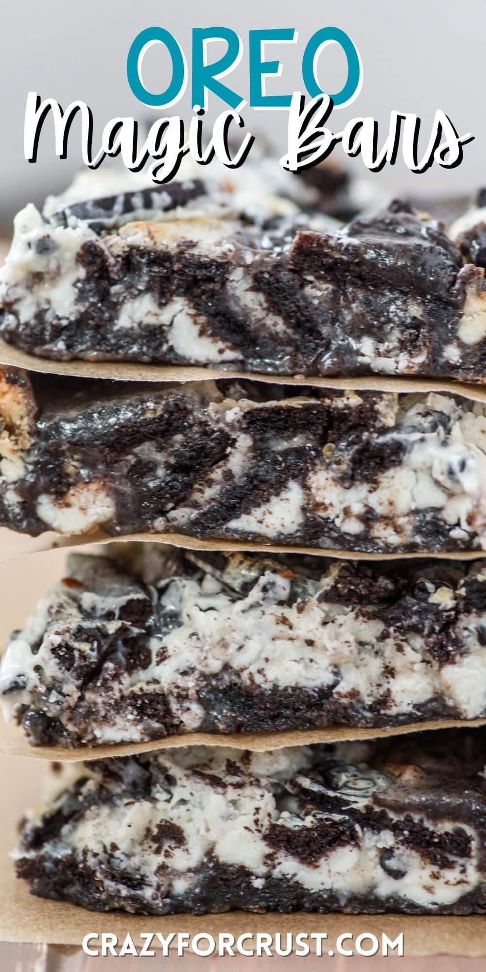 stacked oreo bars with parchment paper in between bars with words on the image.