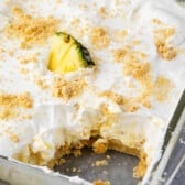 pineapple dessert with cool whip and a pineapple slice on top.