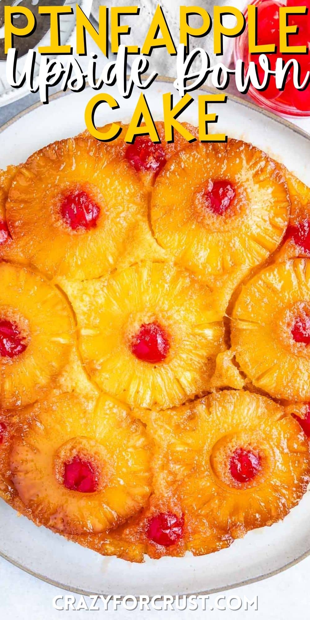 pineapple cake with cherries mixed in with words on the photo.