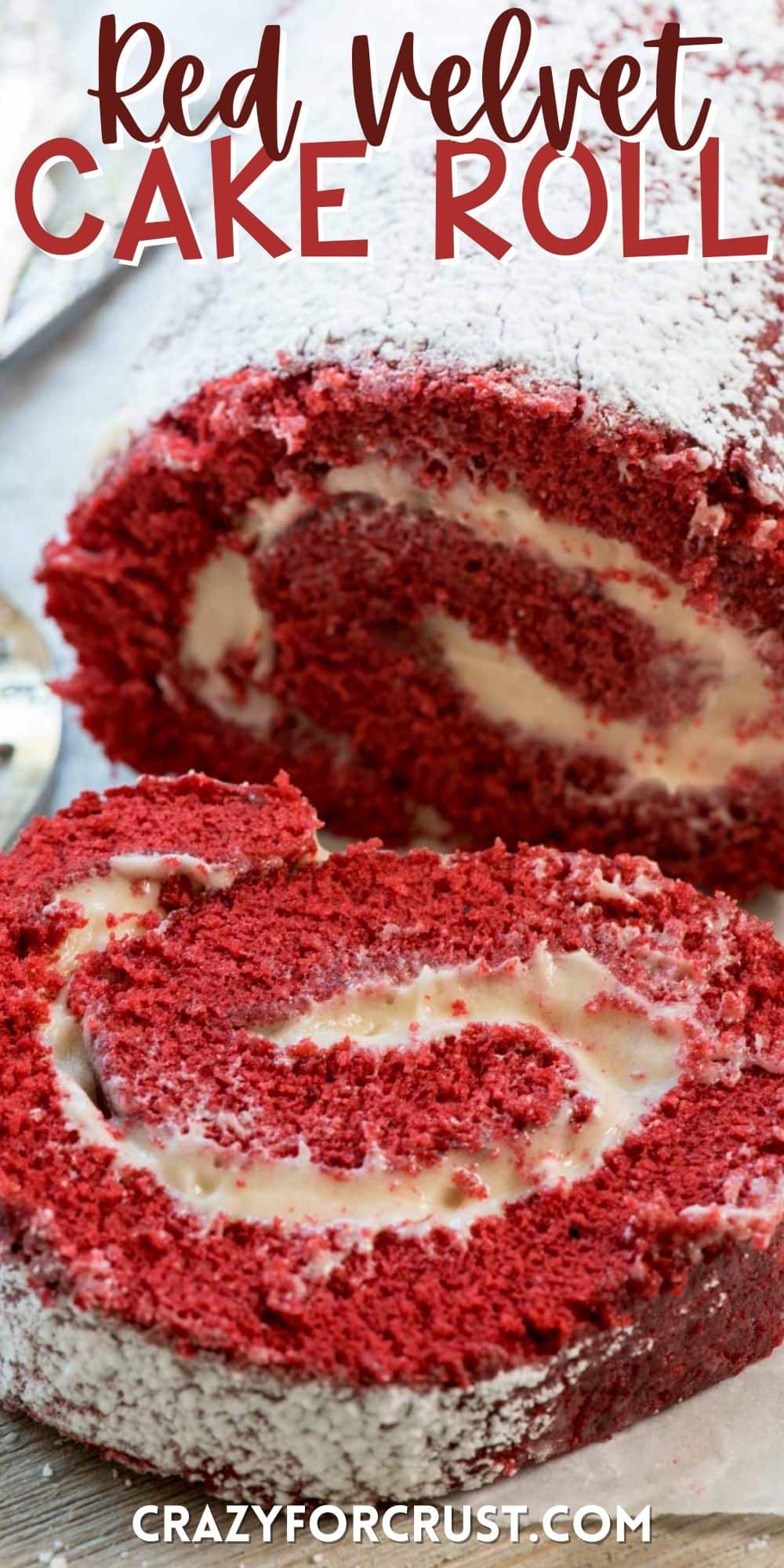 red velvet roll with cream cheese icing rolled in the middle with words on the image.