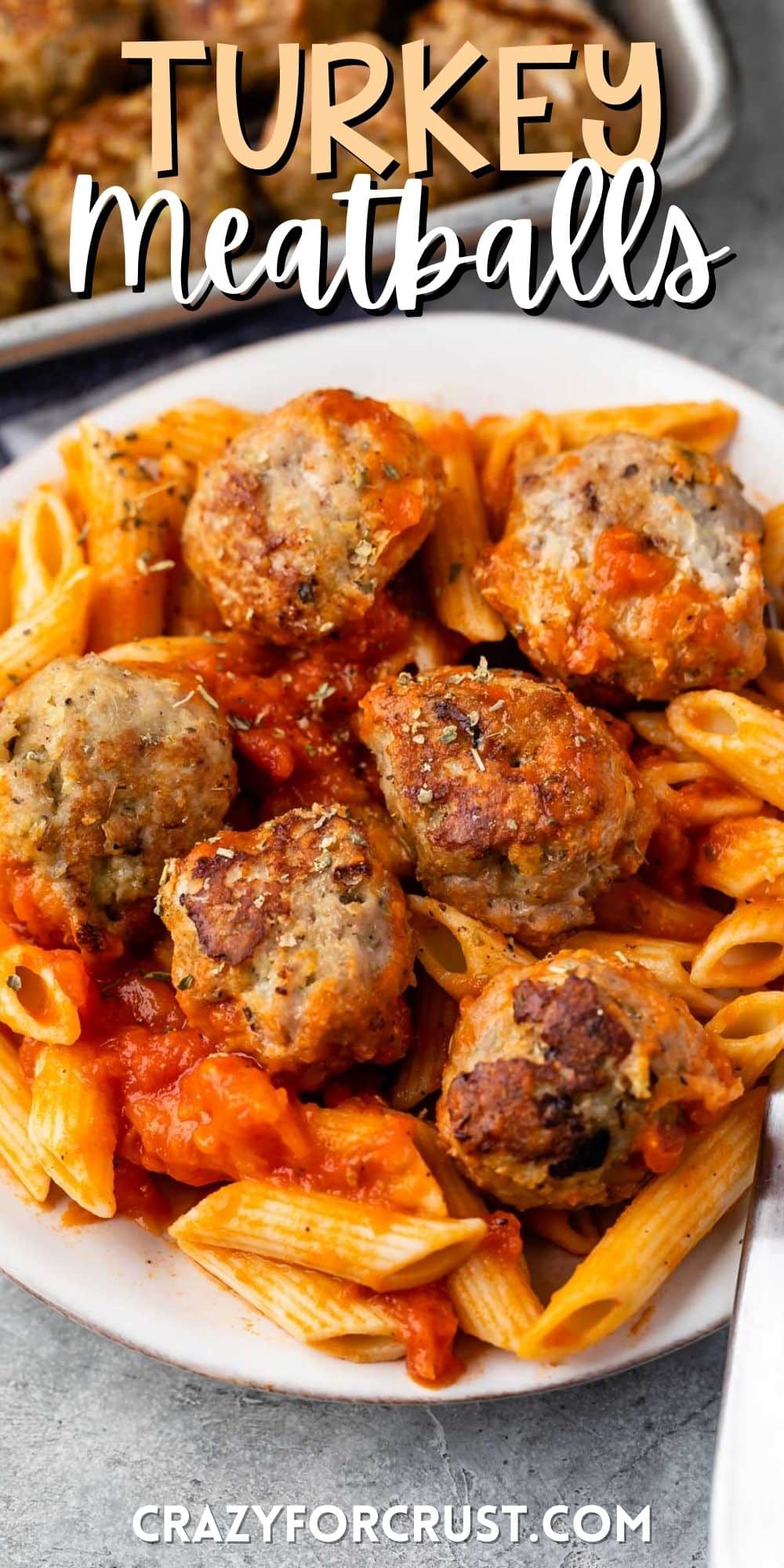 meatballs and pasta mixed together on a white plate with words on the image.