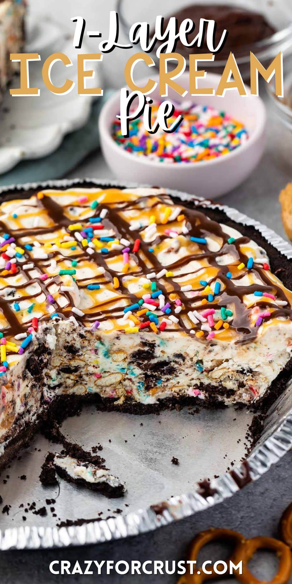 ice cream pie in a pie tin topped with chocolate and caramel sauce and sprinkles with words on the image.
