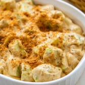 apple salad in a white container covered with crushed butterfinger candy bar.