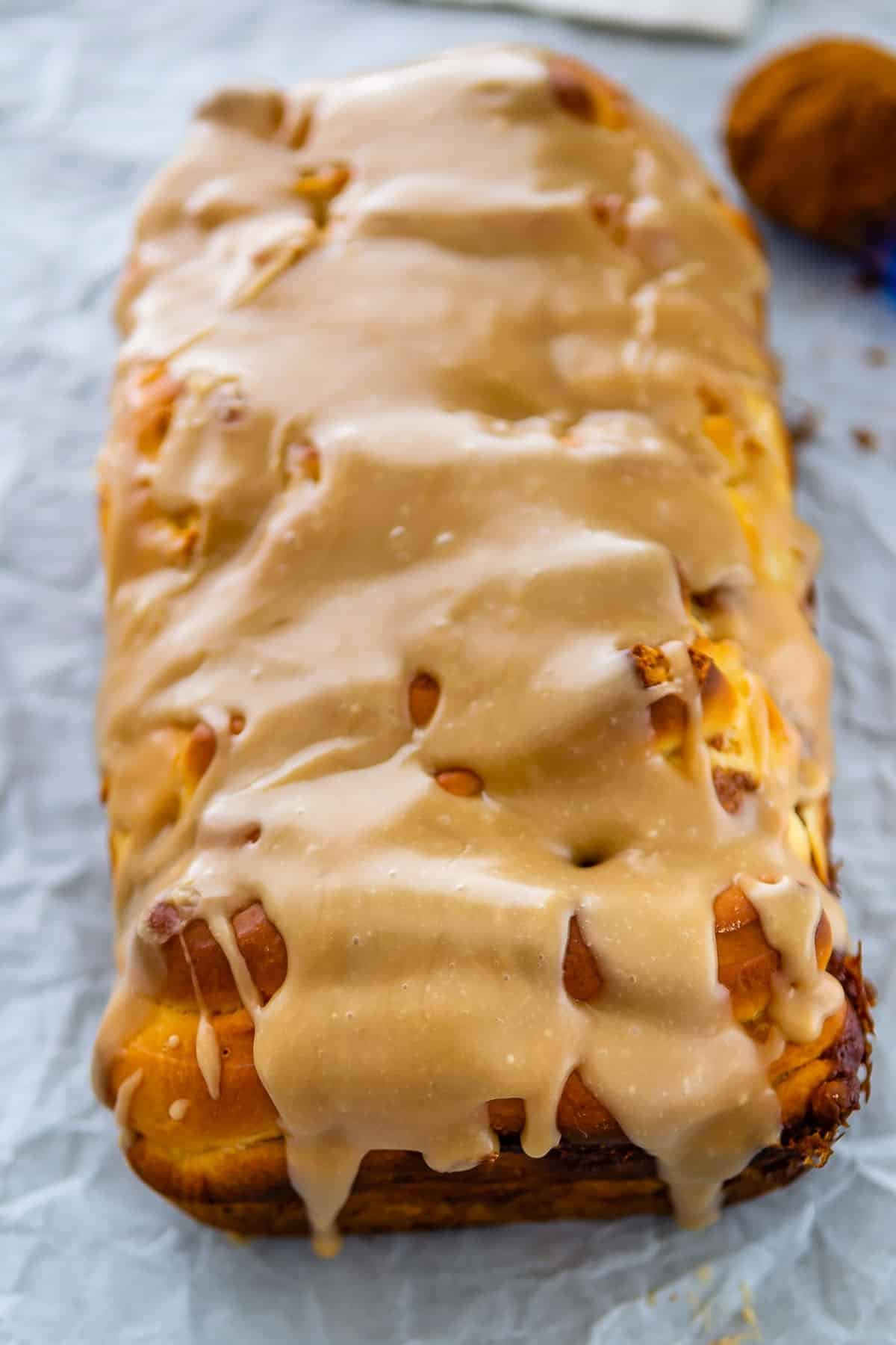 cinnamon roll sliced and topped with a glaze.