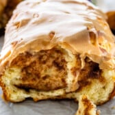 cinnamon roll sliced and topped with a glaze.
