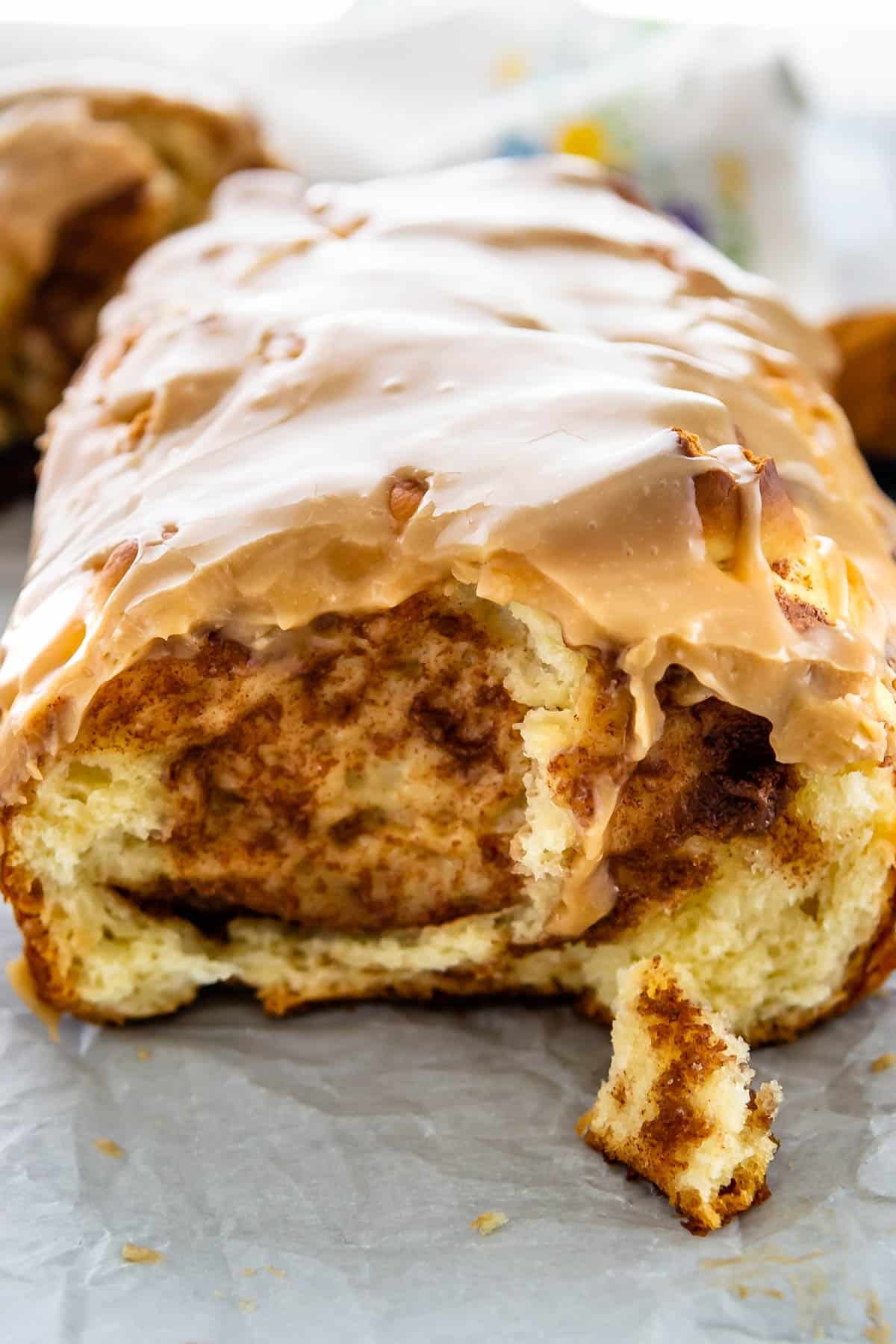 cinnamon roll sliced and topped with a glaze.