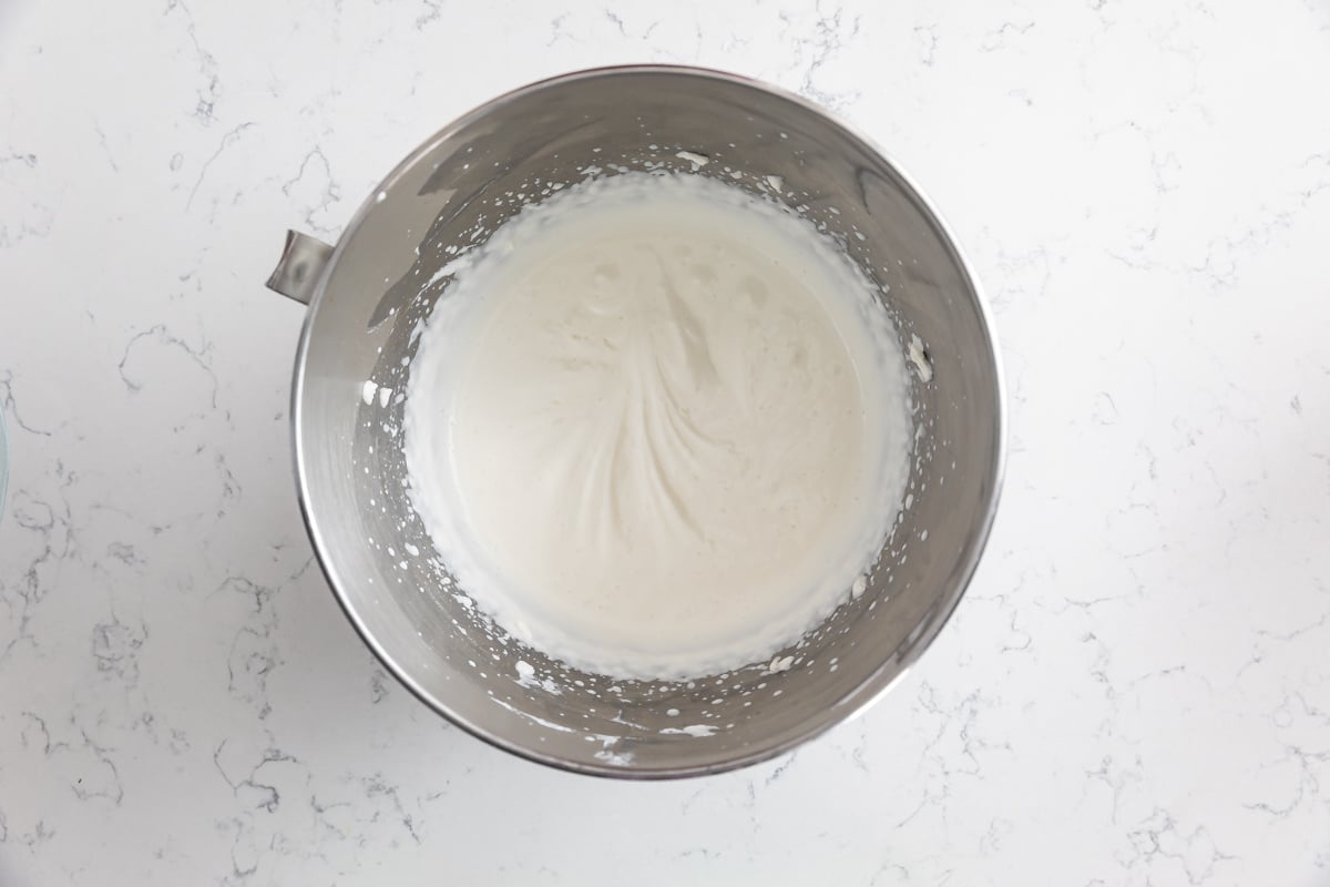 whipped cream with soft peaks in metal bowl.