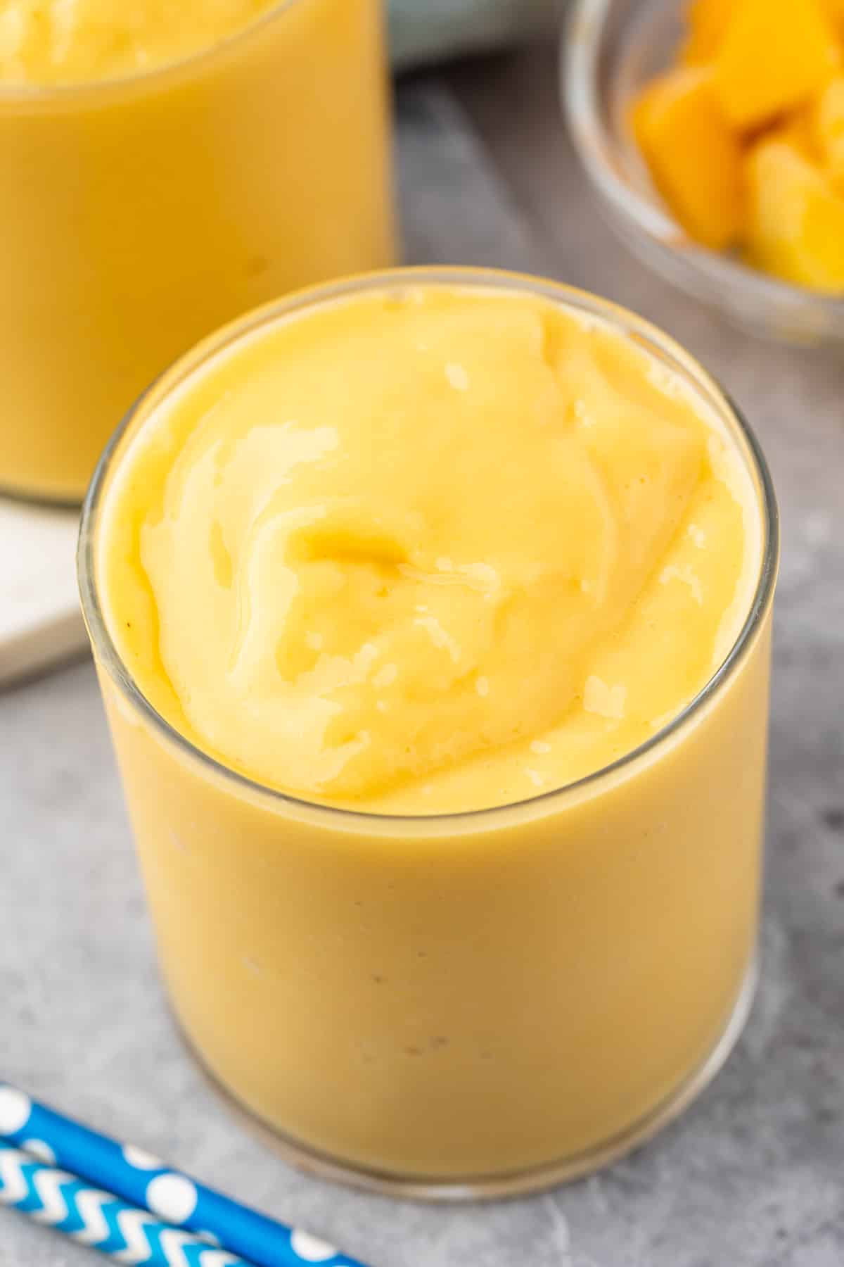 mango smoothie in a short clear glass.
