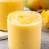 mango smoothie in a short clear glass.