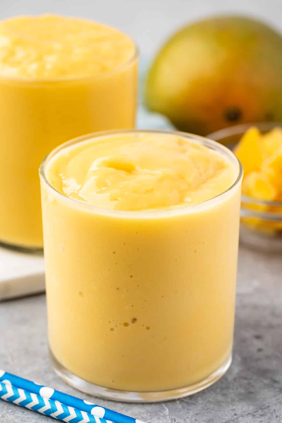 mango smoothie in a short clear glass.