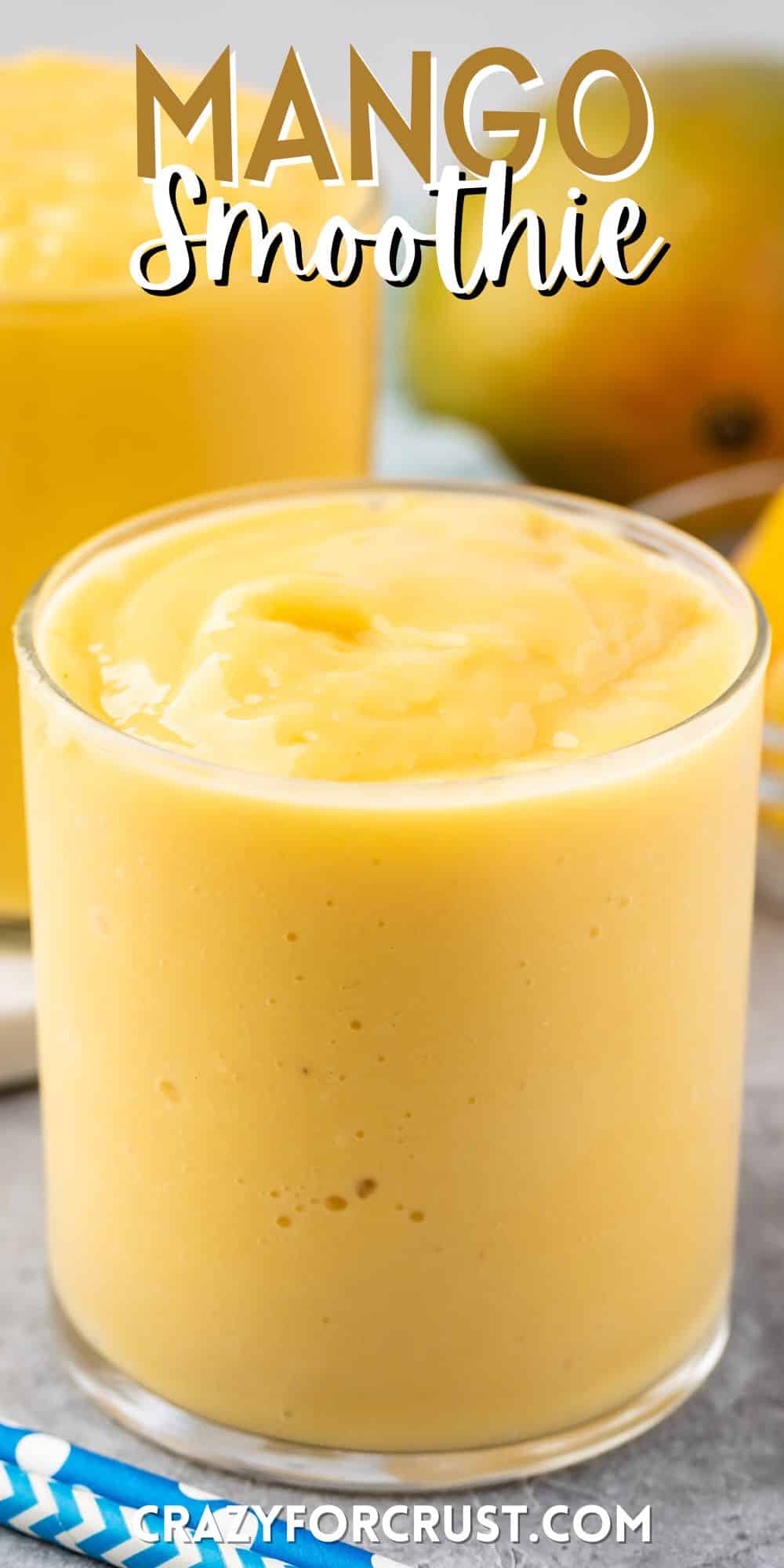 mango smoothie in a short clear glass with words on the image.