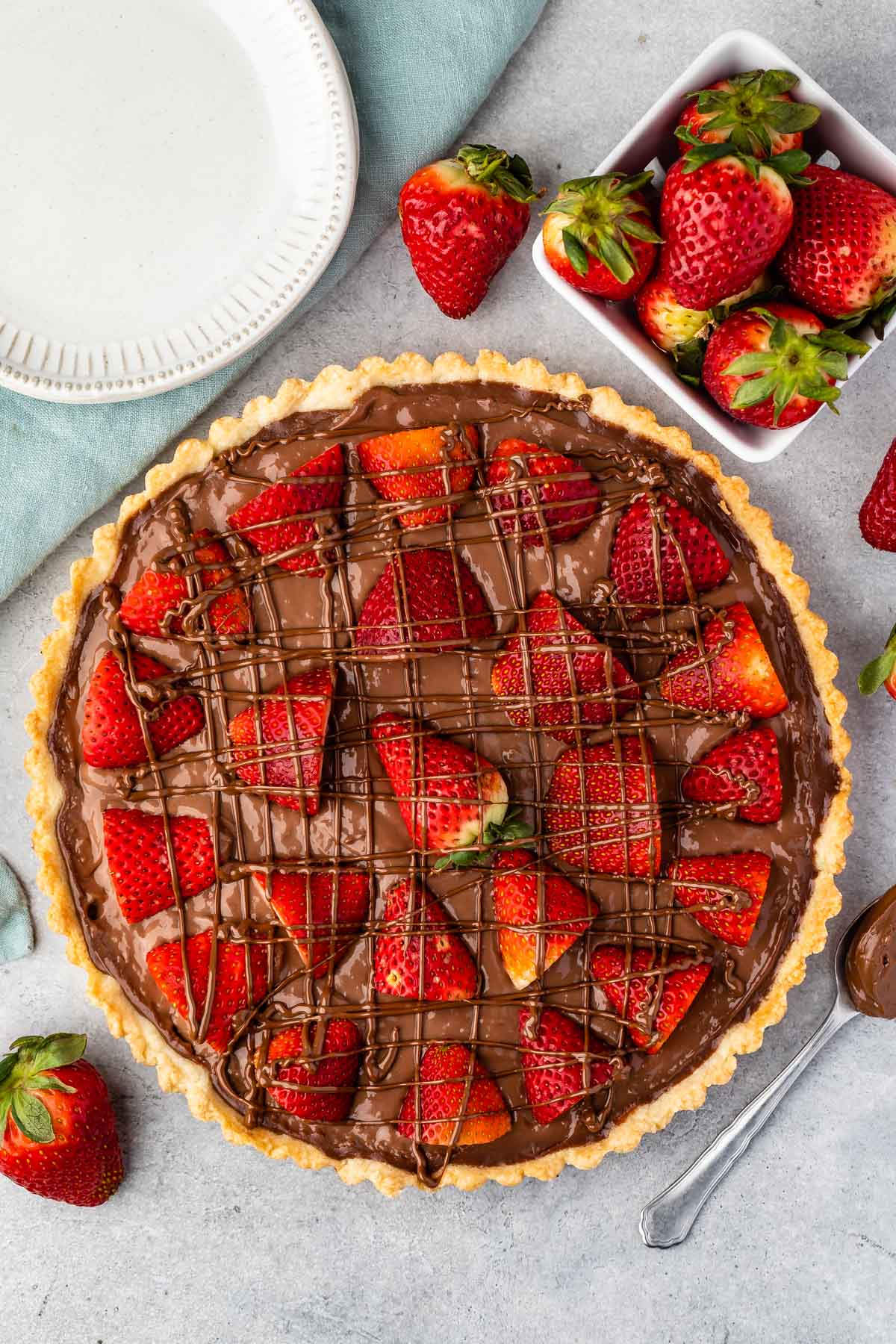 tart in crust covered with chocolate and strawberries.