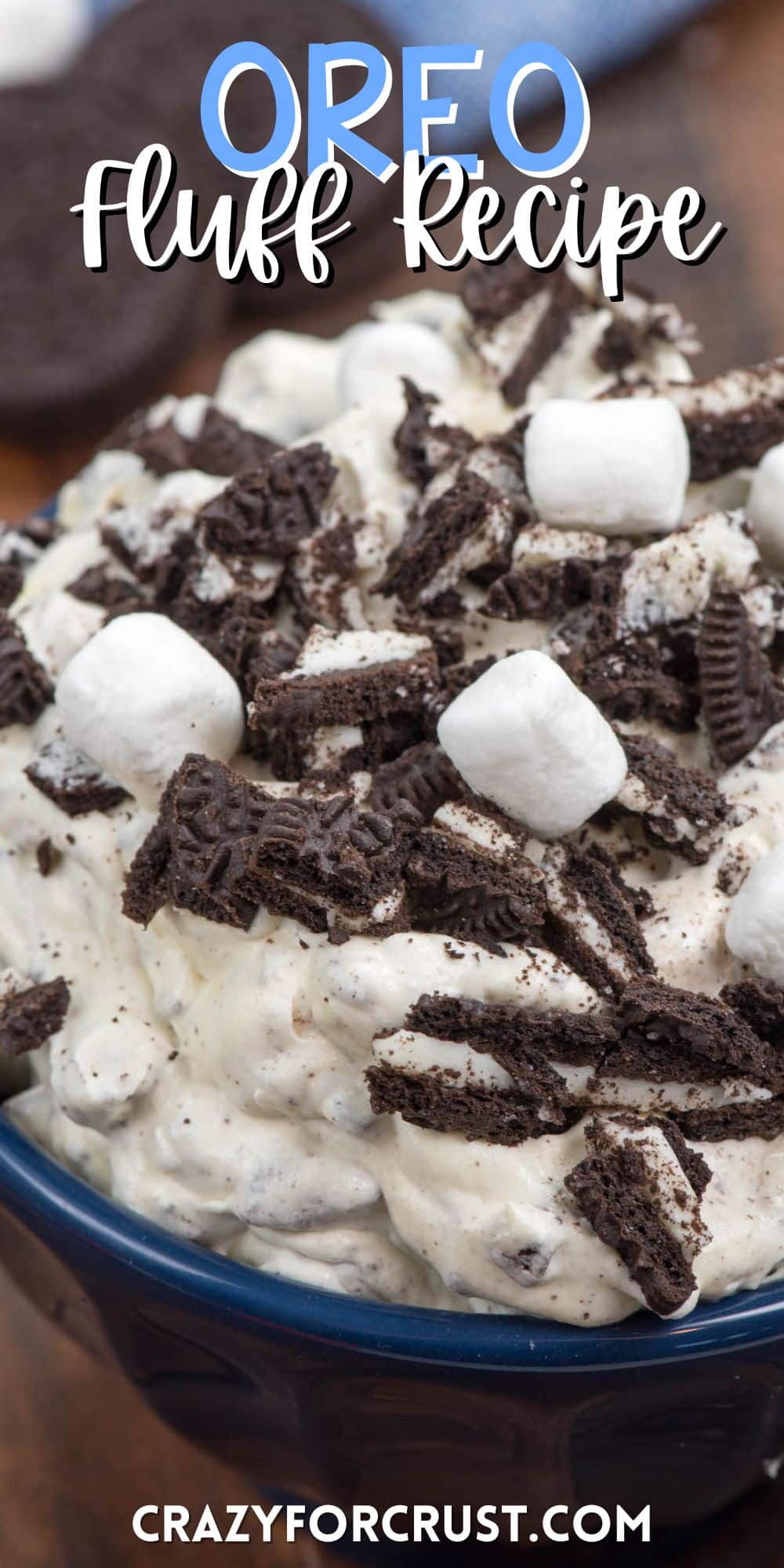 oreo fluff in a blue bowl with marshmallows and chopped oreos on top with words on the image.