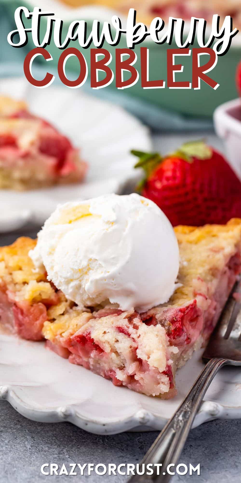 strawberry cobbler on a grey plate with ice cream on top with words on the image.