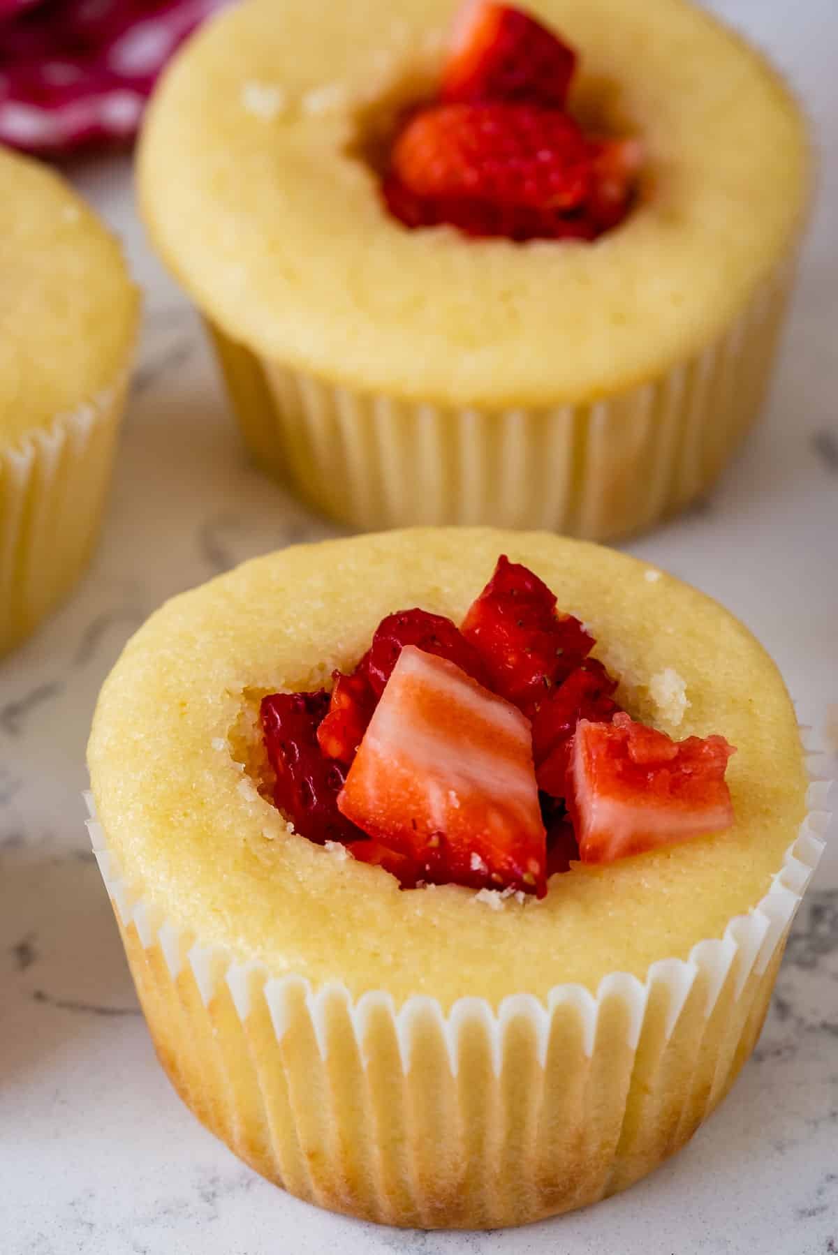 cupcakes with chopped strawberries in the center.