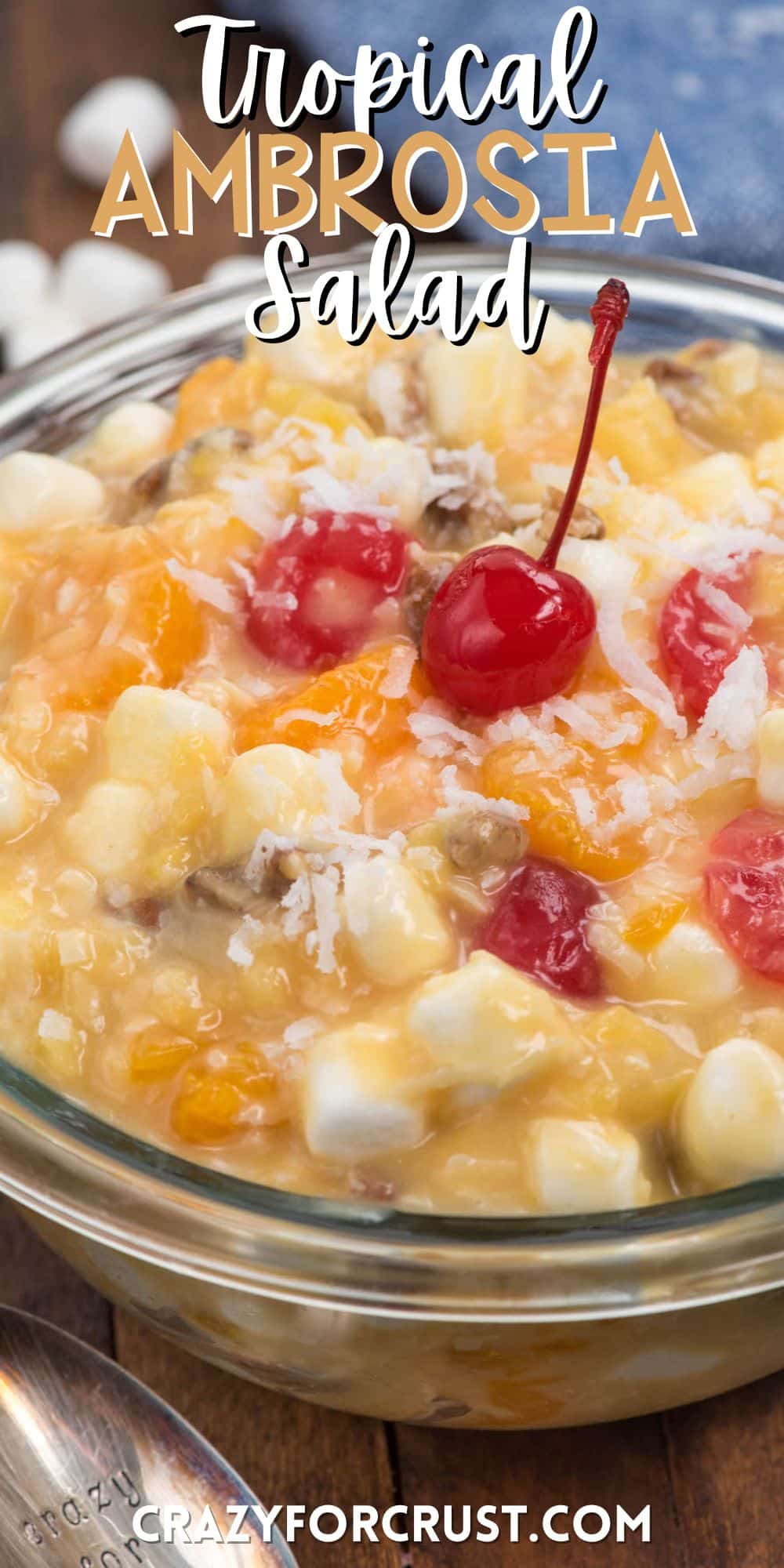 clear bowl with marshmallows and cherries and other ingredients mixed together with words on the image.