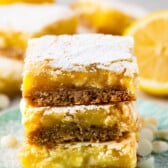 stacked lemon bars topped with powdered sugar.