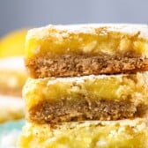 stacked lemon bars topped with powdered sugar.