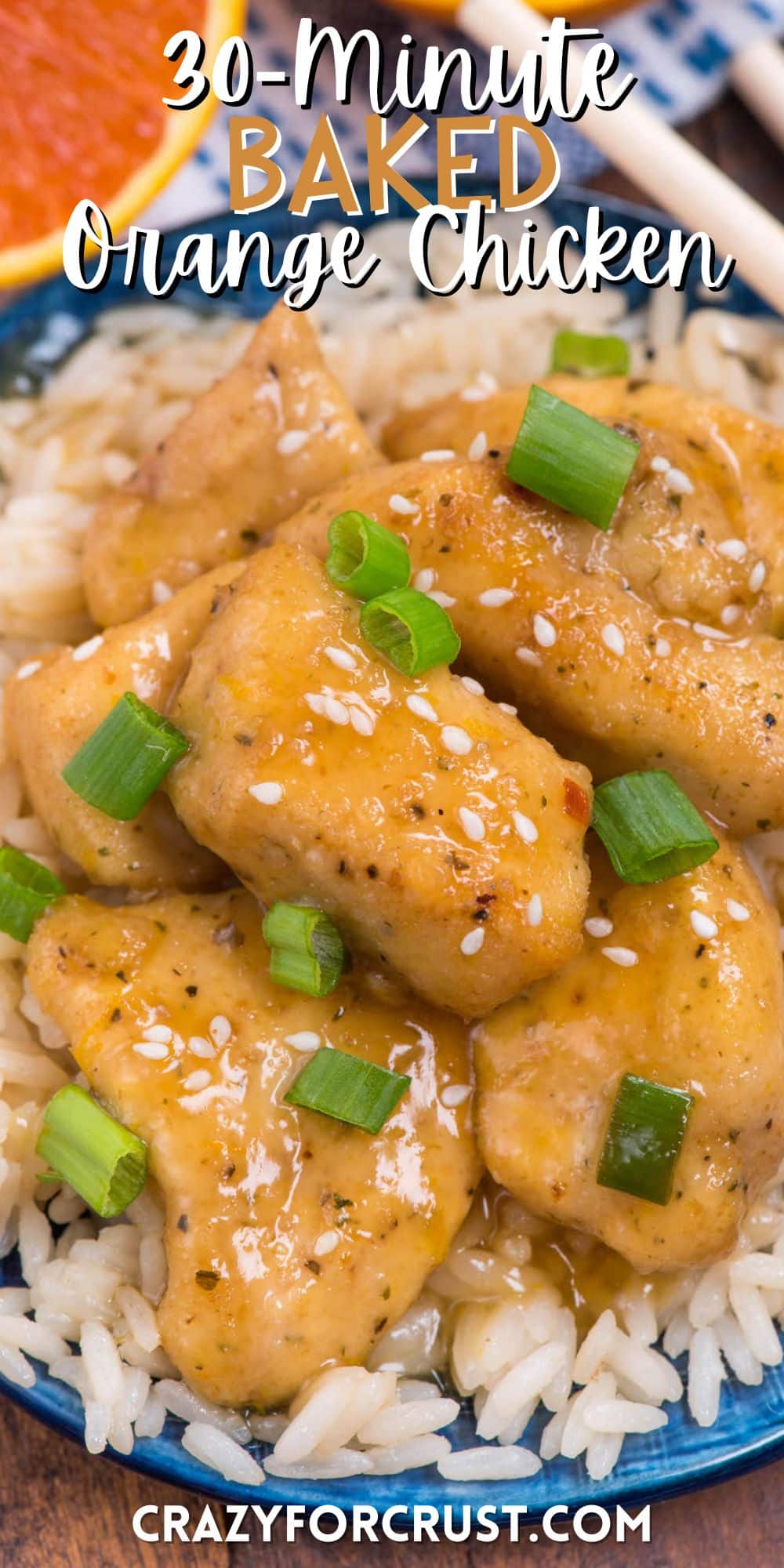 multiple pieces of orange chicken on a pile of rice on a blue plate with words on the image.