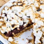 s'mores pie topped with many marshmallows in a white pie plate.