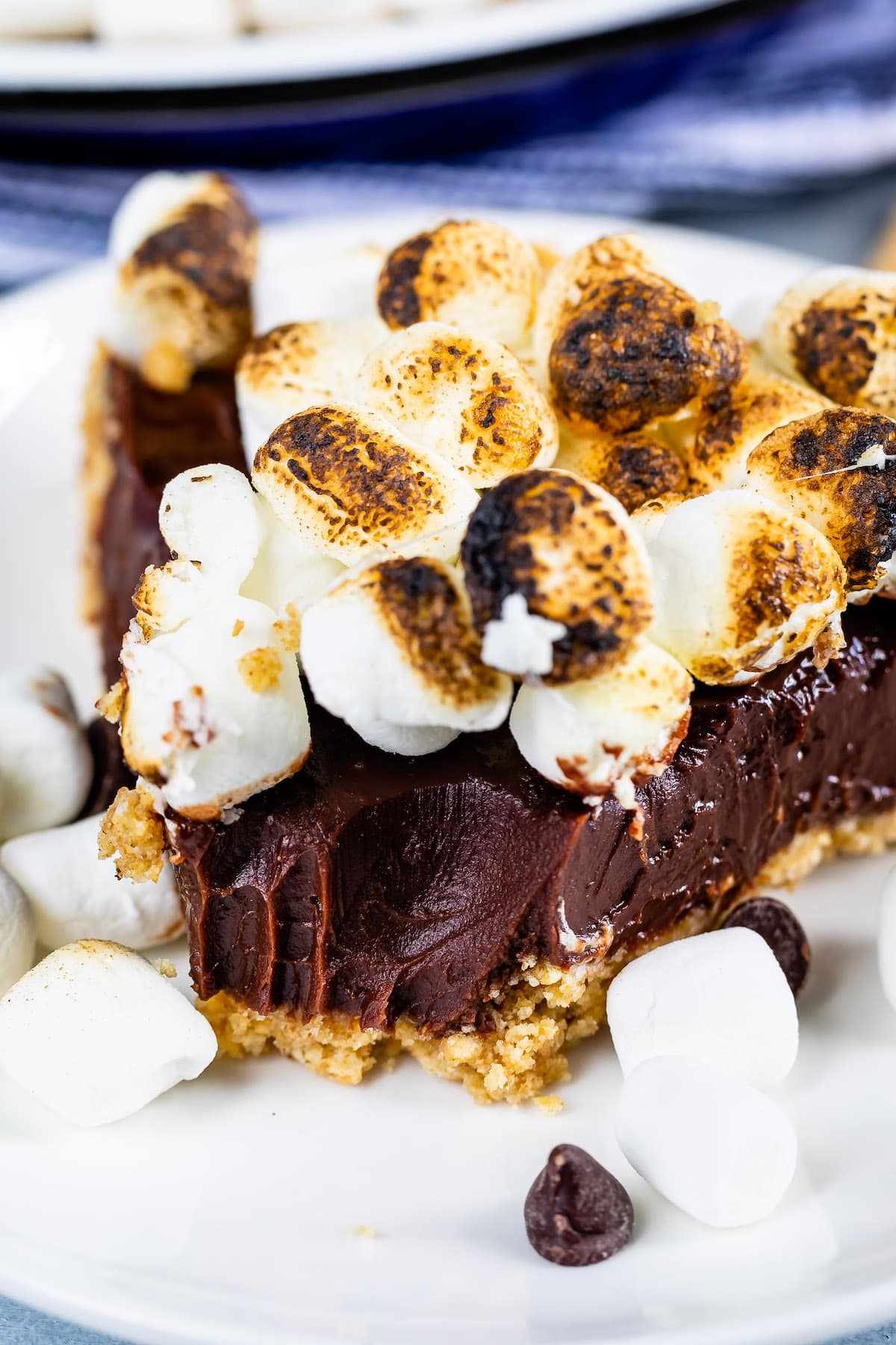 s'mores pie topped with many marshmallows in a white pie plate.