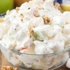 sliced apple and nuts and marshmallows mixed together in a bowl.